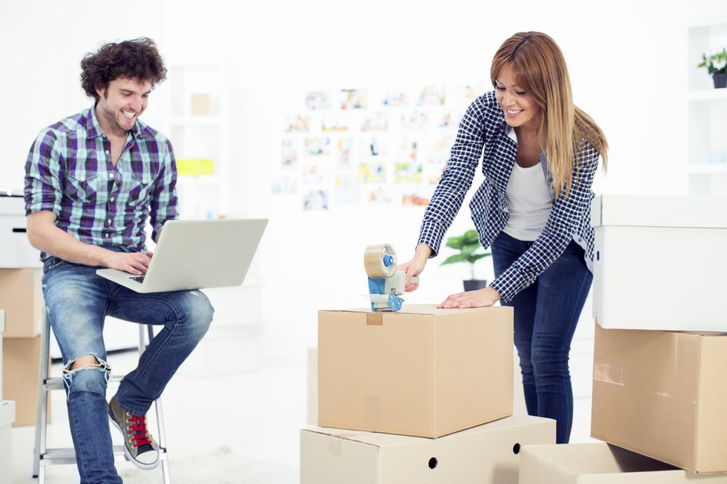 Cheerful young couple moving to new apartment