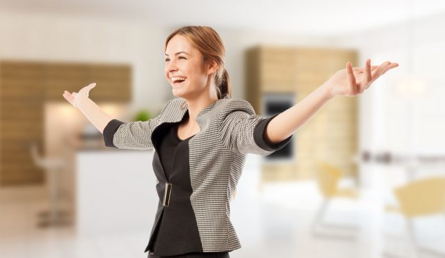 Excited real estate agent or broker with arms wide open