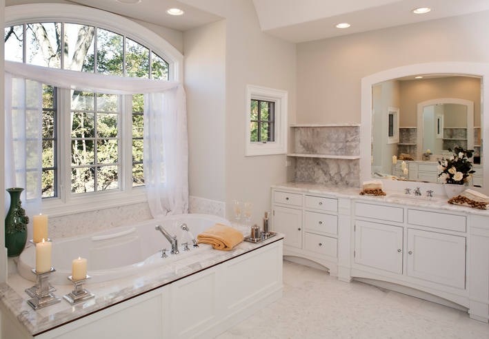 Custom white toned master bathroom with jacuzzi tub