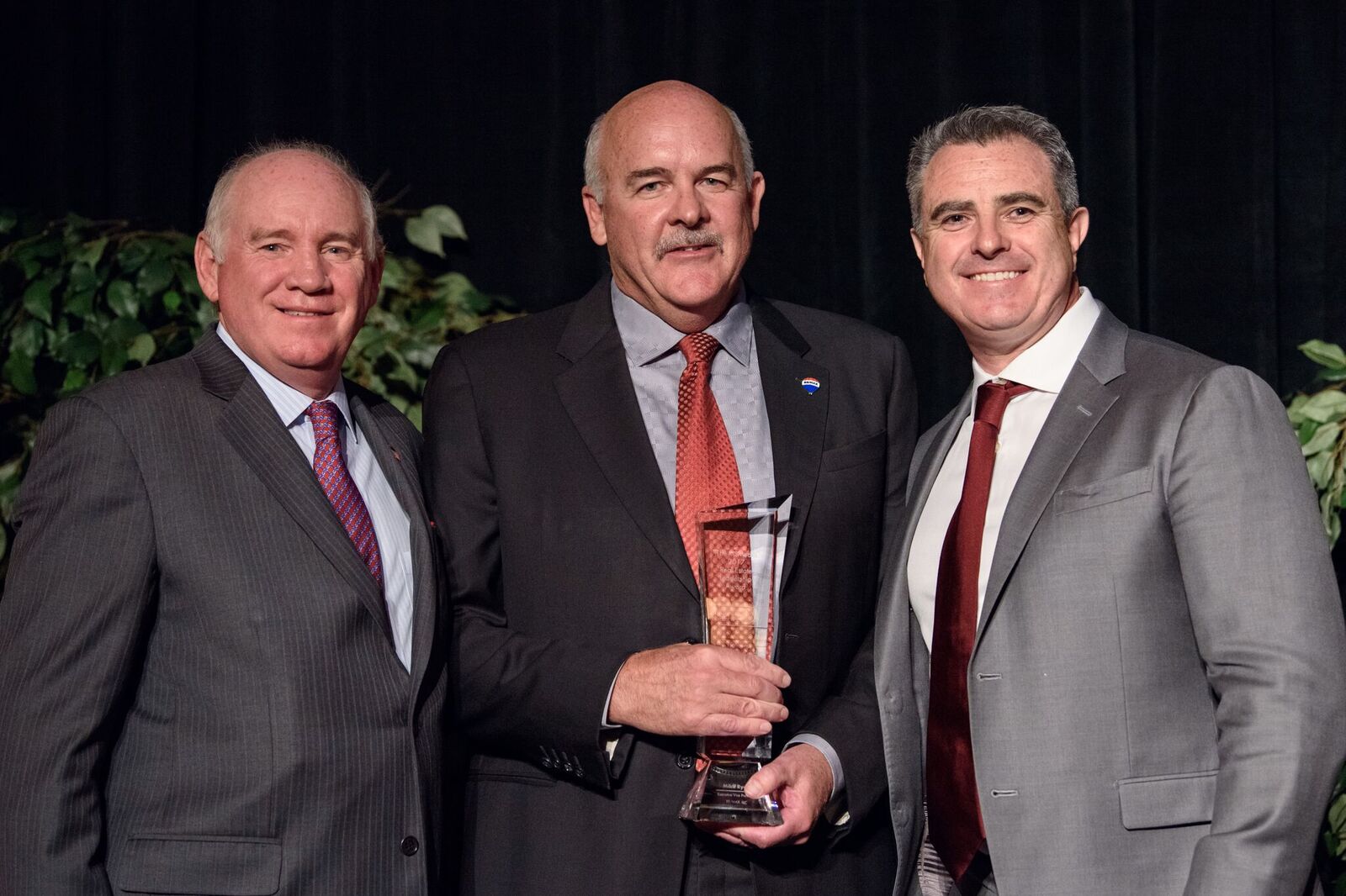 Mike Ryan (center), EVP of RE/MAX, accepts the RISMedia Real Estate Leadership Award, with Featherston (left) and Dermot Buffini (right), CEO of Buffini & Company, sponsor of the award.