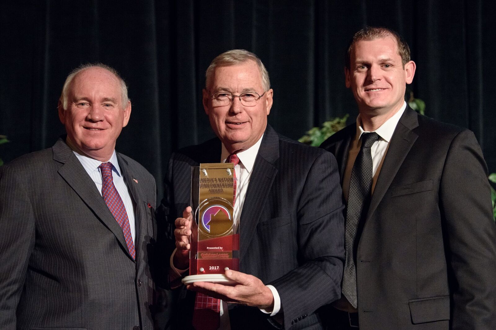 David Caveness (center), president and CEO of Carpenter Realtors, accepts the RISMedia National Homeownership Award, with Featherston (left) and Tom Dempsey (right), divisional VP of National Sales for Quicken Loans, sponsor of the award.